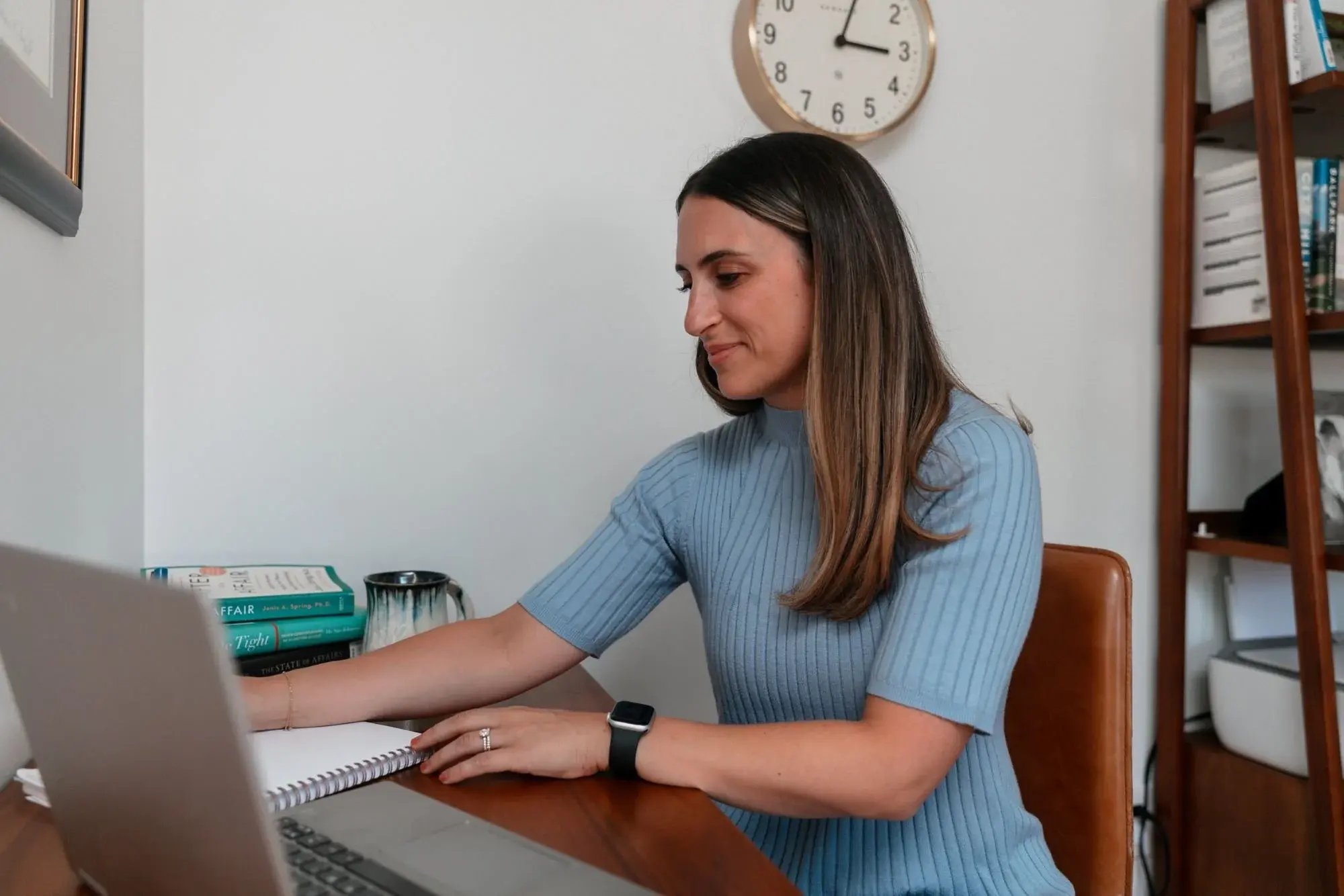 Cara Kraft, LCSW, working at her desk in her Portland, Maine office