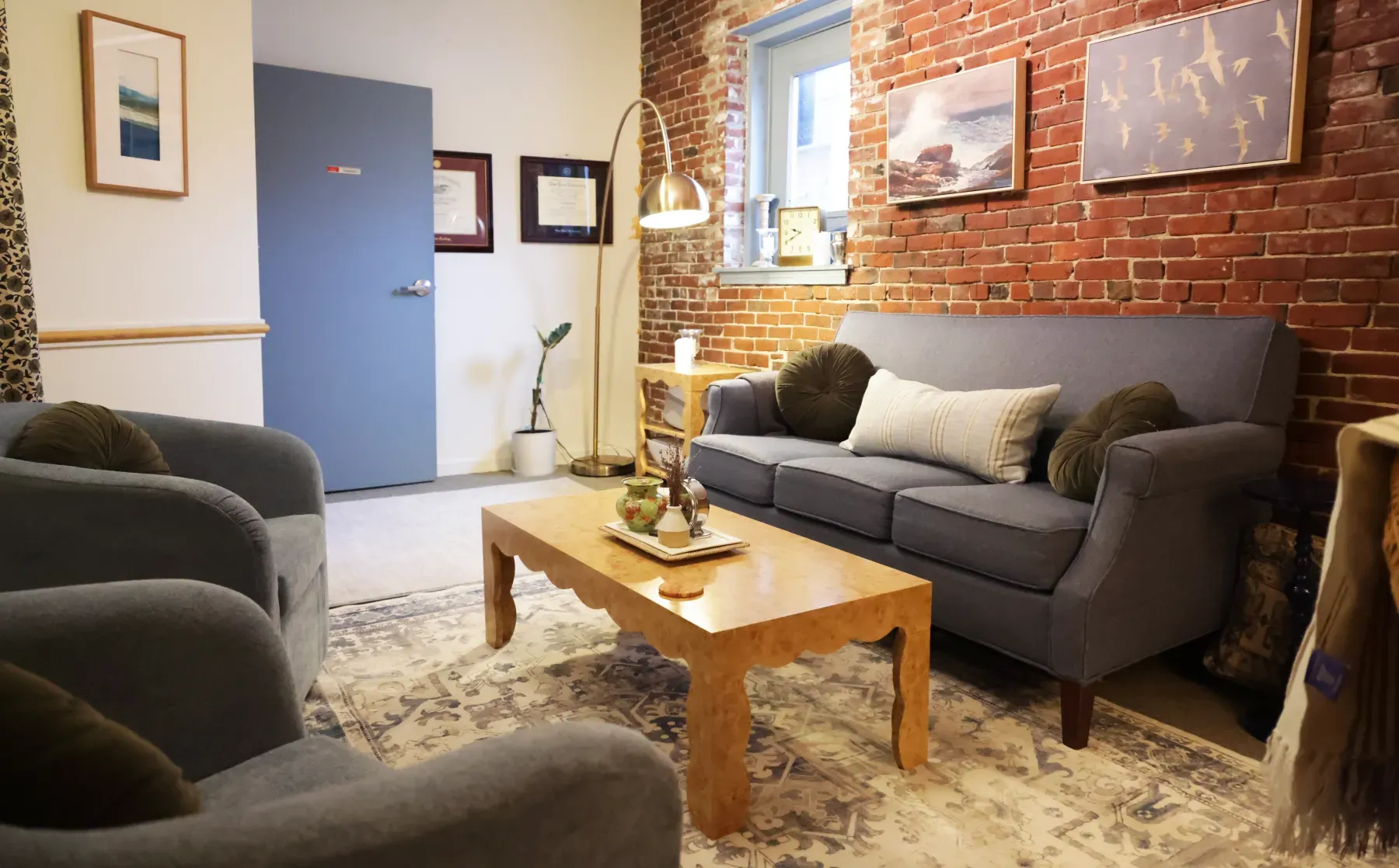 The warm, brick-walled therapy room at Cara's downtown Portland, Maine office